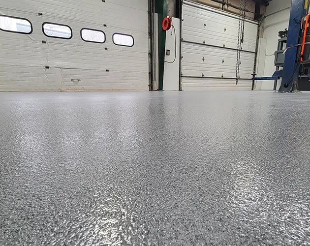 Gainesville, VA decorative quartz floor coatings by STRONGHOLD FLOORS for service bays