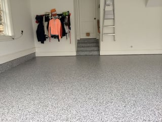 Epoxy coatings by Stronghold Floors added functionality and style to this garage.